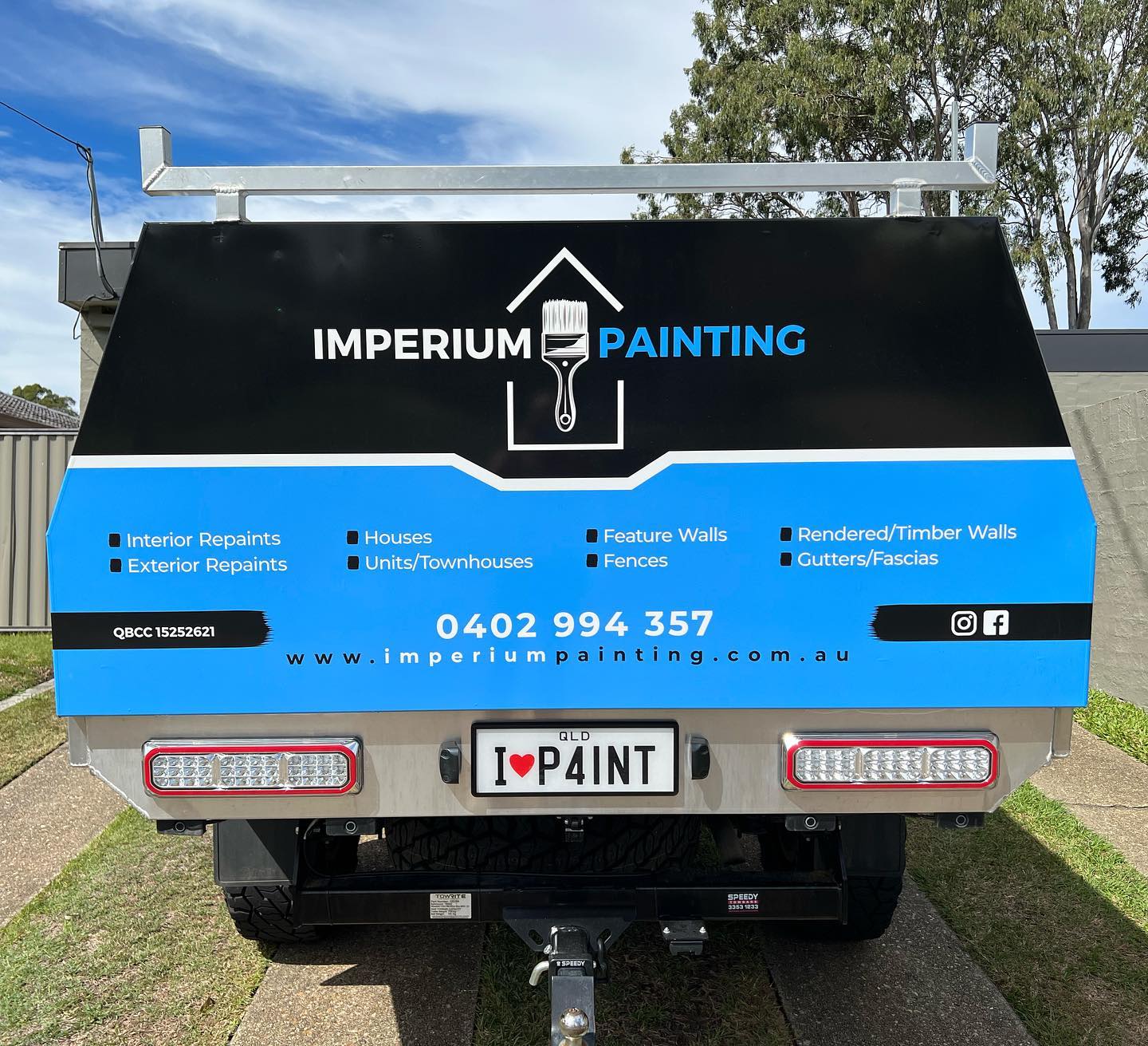 back view of painters work ute with company logo in black and blue branding